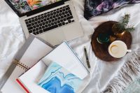 Kaboompics - Bed full of pillows and notebooks with Apple gadgets