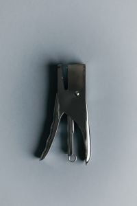 Kaboompics - Metal Stapler on Powder Blue Background