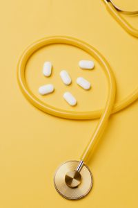 Kaboompics - White Tablets Arranged Inside Stethoscope Tubing, Pharmacy and Healthcare Concept