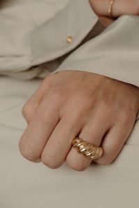 Kaboompics - Close-Up of Chunky Gold Ring on Woman's Hand
