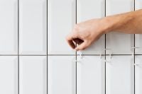 Kaboompics - Laying white ceramic tiles in the bathroom