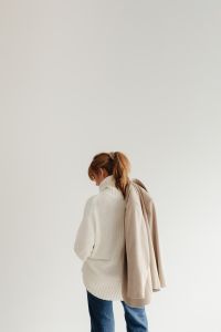 Kaboompics - Faceless Woman in White Sweater and Beige Coat Walking Away