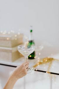 Kaboompics - Two Hands Raising Champagne Glasses for a Toast