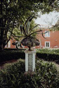 Kaboompics - Agave in a Tiled Pedestal Planter Against a Garden Facade