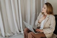 Kaboompics - Seated Businesswoman Taking a Break from Laptop Work