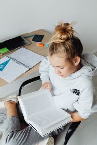 Kaboompics - Overhead Teenager Reading Textbook