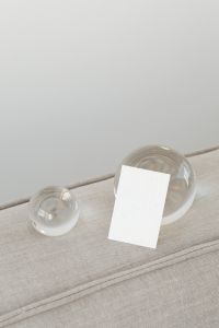Kaboompics - Portrait Card Mockup Between Two Glass Orbs