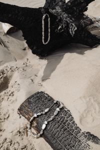 Kaboompics - Silver Necklace and Driftwood on a Sandy Beach