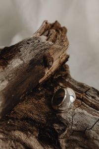 Kaboompics - Chunky Silver Band Ring on Weathered Wood