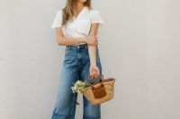 Kaboompics - Woman with Wicker Basket and Small Flower Bouquet on Neutral Background