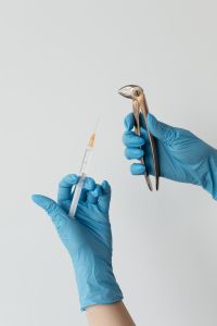 Kaboompics - Tooth Extraction Forceps and Anesthesia Syringe on White