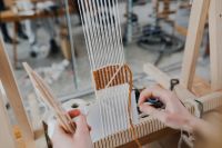 Kaboompics - Woman Using a Wooden Tool While Weaving