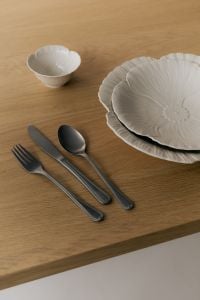 Kaboompics - White Ribbed Ceramic Dinner Plates, Bowl and Silver Cutlery on a Wooden Table