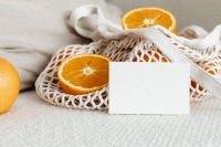 Kaboompics - Landscape Citrus Card Mockup with Whole Orange and Net Produce Bag