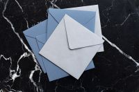 Kaboompics - Blue and White Envelopes on Black Marble, Minimal Stationery Flat Lay