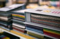 Kaboompics - Interior Design Fabric Swatch Book with Layered Multicolor Upholstery Samples and Palette Cards