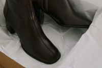 Kaboompics - Brown Leather Ankle Boots in Packaging for Seasonal Wardrobe Inspiration