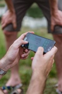 Closeup of man hands playing videogames on cell phone