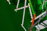 Kaboompics - Extandable wooden ruler on a green background