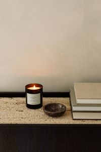 Kaboompics - Minimal Travertine Console Still Life with Candle, Stone Bowl and Stacked Books