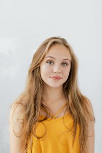 Kaboompics - Soft Smile Blonde Teen Portrait in Mustard Yellow Top
