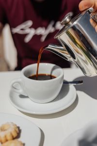 Kaboompics - Pouring coffee into a cup. Silver kettles, Italian cookies.