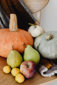 Kaboompics - Orange Pumpkin and Green Pears on a Plaid Blanket, Vertical Autumn Harvest Still Life