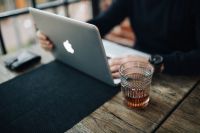 Kaboompics - Writer's workplace - laptop and glass of whiskey