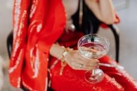 Kaboompics - Close-Up Champagne Coupe over a Sparkling Red Party Outfit