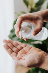 Kaboompics - Side View of Clear Sanitizer Bottle Above Open Palm