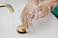 Kaboompics - Close-Up of Lathered Hands under Running Water at a Sink, Hand Hygiene Awareness
