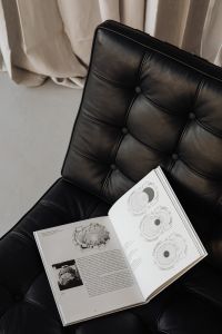 Open Book on Black Leather Chair in a Contemporary Interior