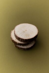 Kaboompics - Single Slice of Root Vegetable on Olive Green Background