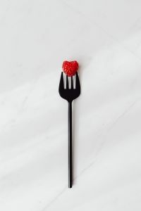 Kaboompics - Raspberry On Black Fork On White Marble