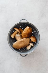 Kaboompics - Close-Up of Boletus Mushrooms in a Black Colander