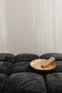 Kaboompics - Mother-of-Pearl Bowl with Palo Santo on a Black Textured Ottoman