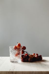 Kaboompics - Close Crop of Red Grapes in a Cut Glass on White Stone