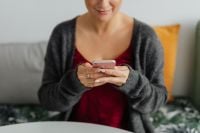 Kaboompics - A brunette woman works with a laptop and a phone