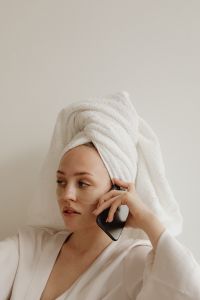 Kaboompics - Woman on a Phone Call with Eye Patches and Towel-Wrapped Hair
