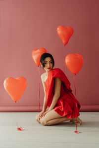 Kaboompics - Red Dress Fashion Editorial With Heart-Shaped Balloons
