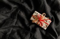 Kaboompics - Group of Wrapped Gifts on a Dark Bedspread
