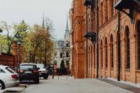 Kaboompics - Parked Cars on the Manufaktura Brick Factory Street with Historic Łódź Architecture Beyond