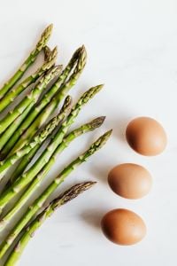 Kaboompics - Raw Asparagus Spears with Brown Eggs on White Background, Healthy Food Ingredients
