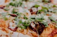 Kaboompics - Pizza with Arugula and Restaurant Tableware Seen from Above