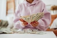 Kaboompics - Faceless Close-Up of Woman Holding Dollar Bills