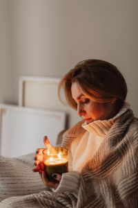 Kaboompics - Woman Holding a Candle During a Cozy Home Evening