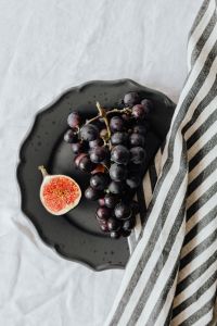 Fig, Grape and Citrus on Black Stoneware for Food Styling