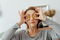 Kaboompics - Woman Looking Through Bitcoin Coins