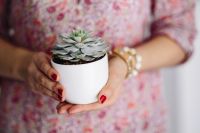 Kaboompics - Woman in pink holding a plant