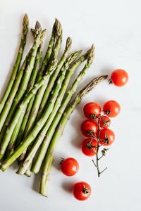 Kaboompics - Green Asparagus and Cherry Tomatoes on White, Fresh Cooking Ingredients